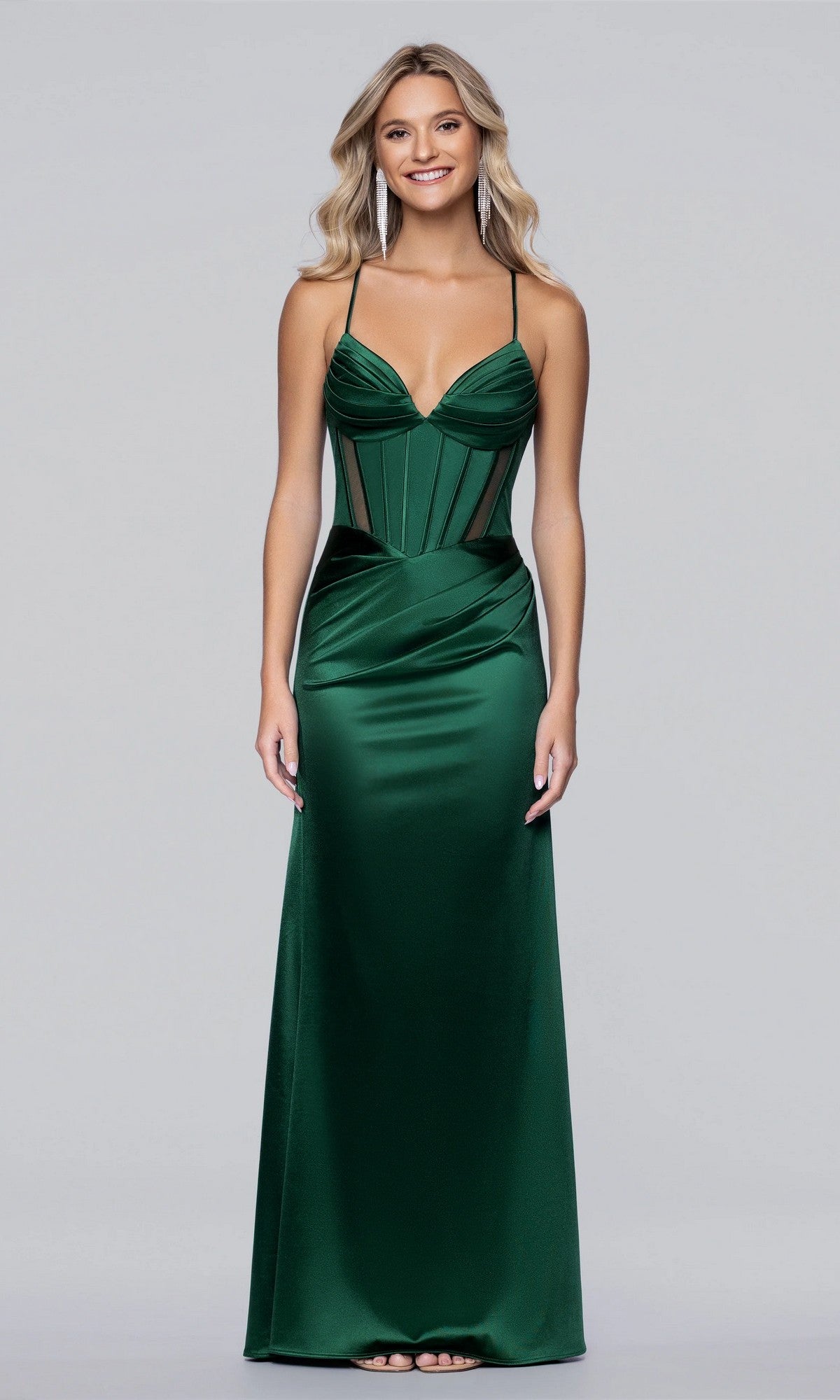 A woman faces forward, wearing the Blondie Nites 6014BN long prom dress in hunter—a floor-length, fitted satin gown with thin straps and a structured corset bodice, set against a plain background.